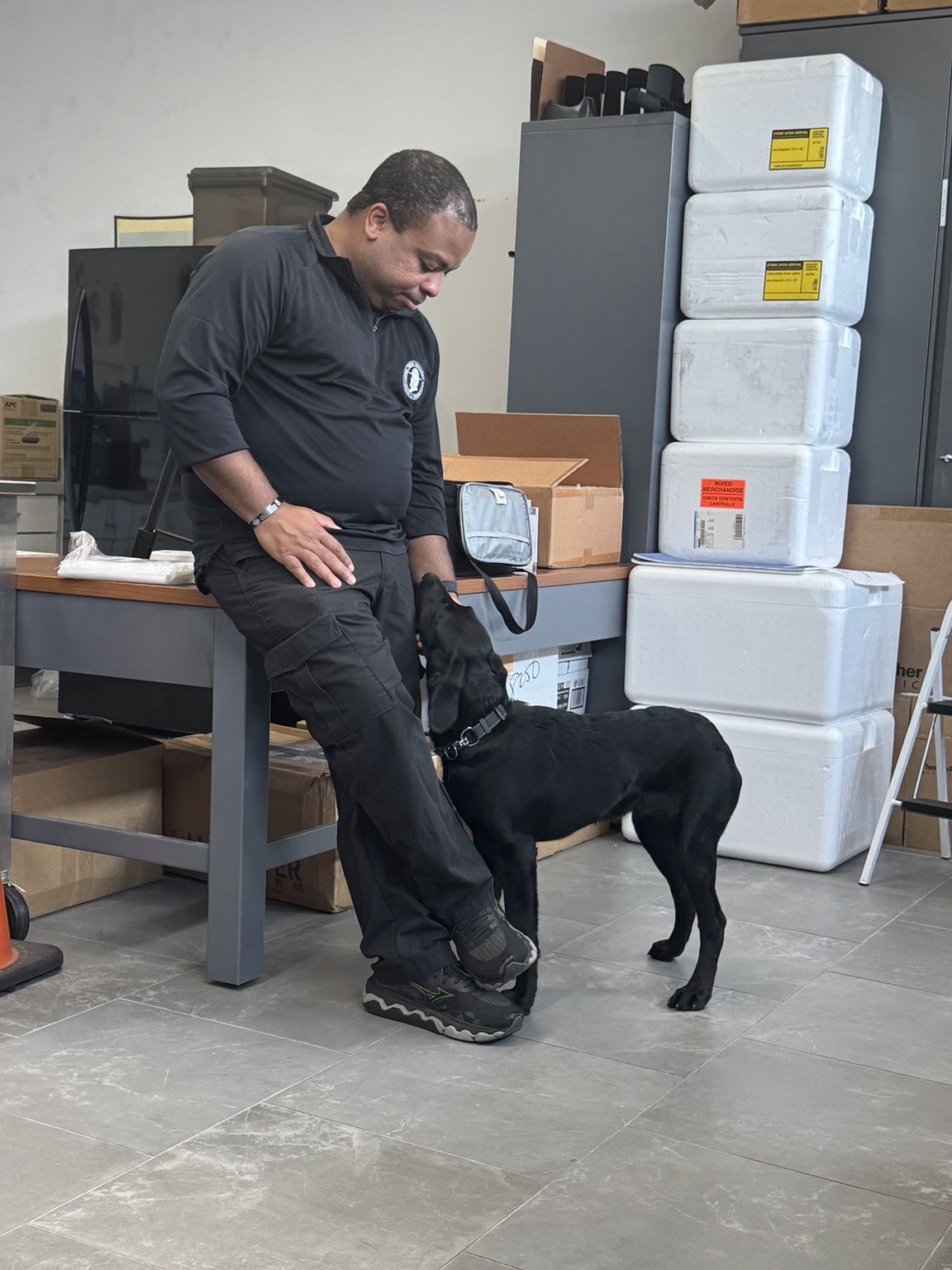 Therapy dog providing comfort during first responder outreach visit